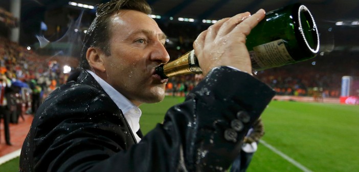 Belgium's soccer team coach Wilmots celebrates with champagne after a 2014 World Cup qualifying soccer match against Wales in Brussels